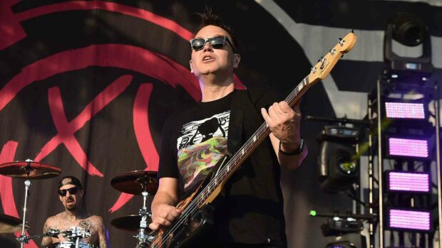 Mark Hoppus is performing on stage wearing sunglasses and a black shirt while playing bass guitar, HD Desktop Wallpaper
