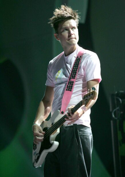 Mark Hoppus playing bass guitar during a live performance wearing a pink shirt, 2K Mobile Wallpaper
