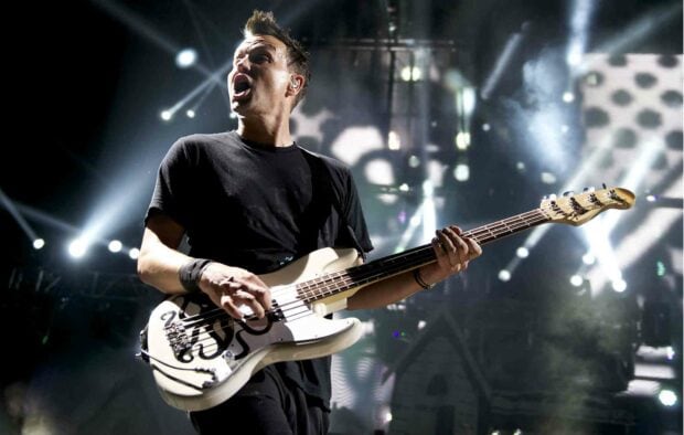 Mark Hoppus passionately playing bass guitar on stage during a concert, HD Desktop Wallpaper