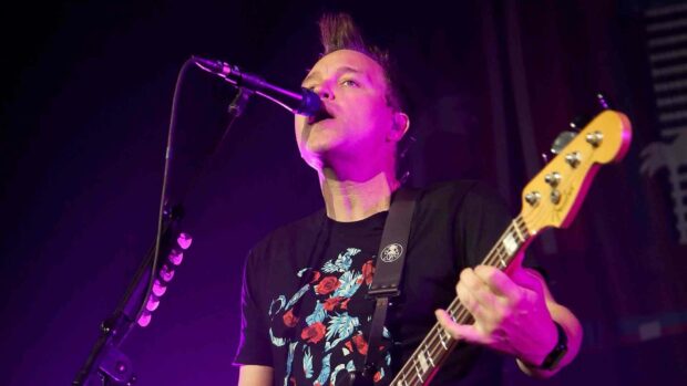 Mark Hoppus is performing live on stage with a bass guitar and microphone, HD Desktop Wallpaper