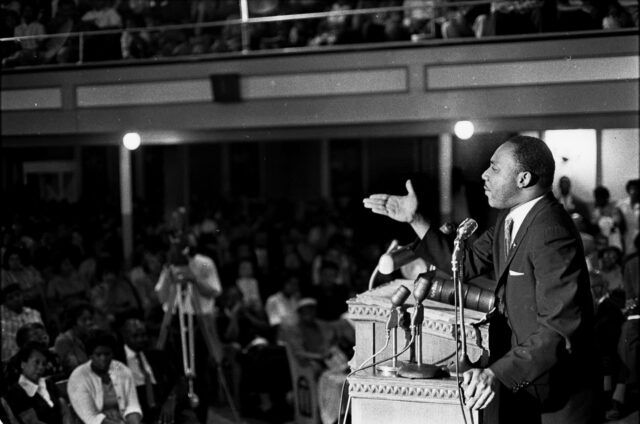 Martin Luther King Jr. Delivering A Speech To A Crowd