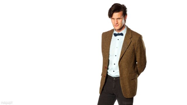 Matt Smith as the Eleventh Doctor in Doctor Who standing confidently in a brown jacket and bow tie, 2K Desktop Wallpaper