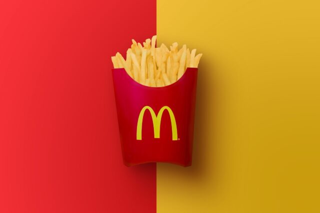 McDonalds French Fries in Red Container on Red and Yellow Background Wallpaper
