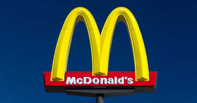 McDonalds Logo Bright Yellow Sign on Clear Blue Sky Background Wallpaper