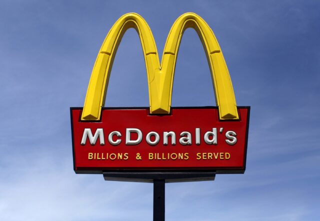 McDonalds Logo Sign with Billions Served Clear Sky Background Wallpaper