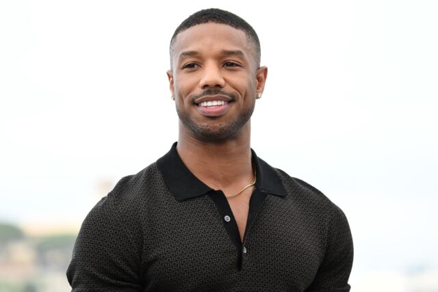 Michael B Jordan Smiling in Casual Black Polo Shirt Wallpaper