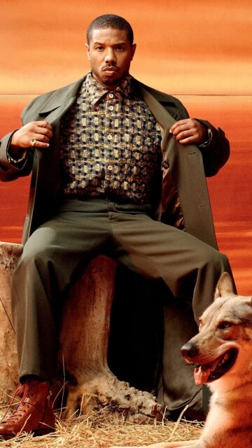 Michael B Jordan Stylish Pose with Dog in Fashionable Outfit Wallpaper