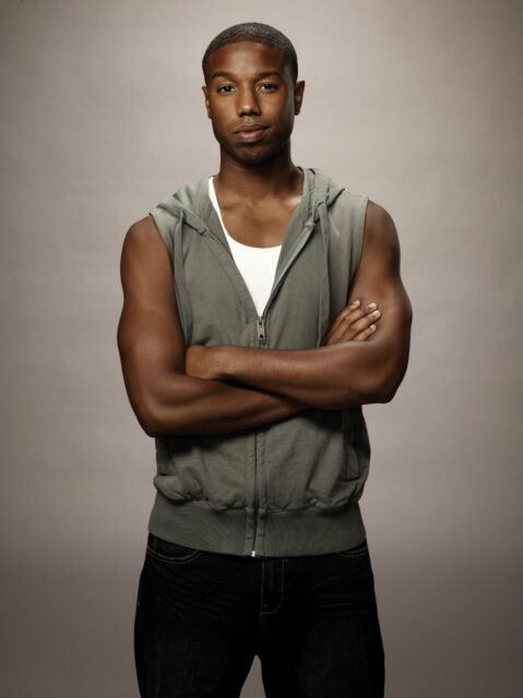 Michael B Jordan casual pose sleeveless hoodie gray background wallpaper