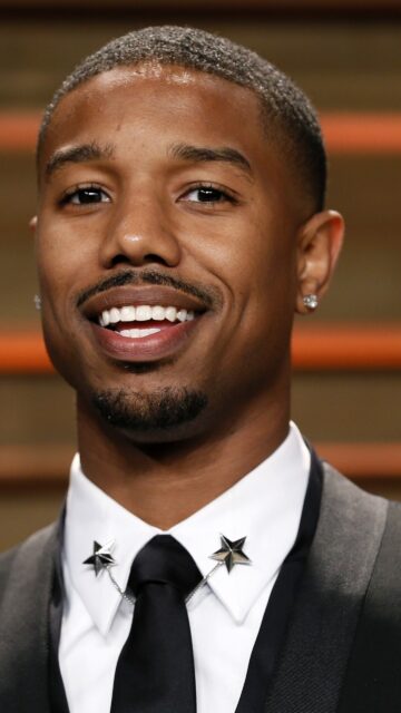 Michael B Jordan close up portrait smiling in formal suit star collar pins wallpaper