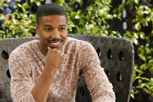 Michael B Jordan smiling casually in cozy sweater outdoor portrait wallpaper