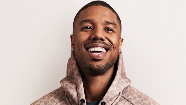 Michael B Jordan smiling in stylish hoodie perfect for wallpapers and backgrounds