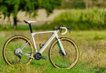 A 3T bike with yellow tires stands on a grassy field under natural light, HD Desktop Wallpaper