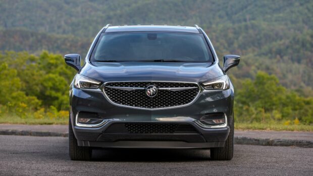 The Buick Enclave is shown from the front with a forest background, 4K Desktop Wallpaper