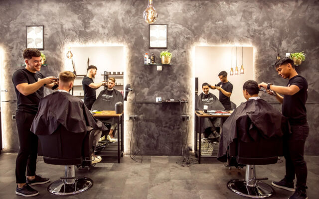 Modern Hair Salon Interior With Professional Barbers At Work