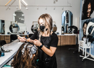 Modern Hair Salon Interior With Stylist At Work
