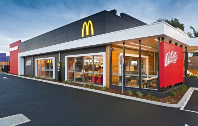 Modern Mcdonalds Restaurant Exterior with McCafe Section in Evening Light Wallpaper