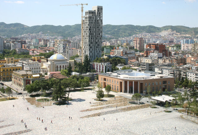 Modern Skyline Of Tirana Albania With Scenic Hills Background