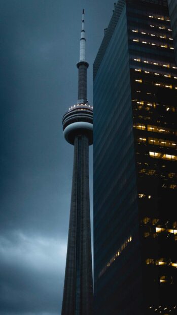 The CN Tower stands tall beside a lit office building during dusk in Canada, HD Mobile Wallpaper
