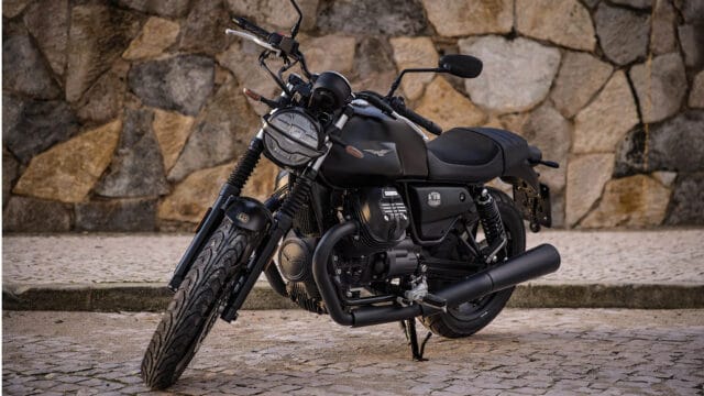 Moto Guzzi V7 Black Motorcycle Parked on Stone Pavement Wallpaper