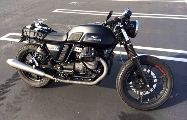 Moto Guzzi V7 Classic Black Motorcycle Parked in Sunlit Parking Lot Wallpapers