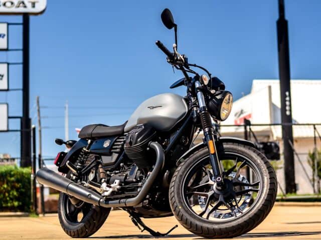 Moto Guzzi V7 Classic Motorcycle Parked Under Clear Blue Sky Wallpaper