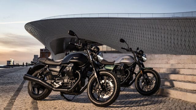 Moto Guzzi V7 Classic and Stone Models Parked with Modern Architecture Background
