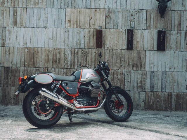 Moto Guzzi V7 Racer Classic Motorcycle Parked Against Wooden Wall Background