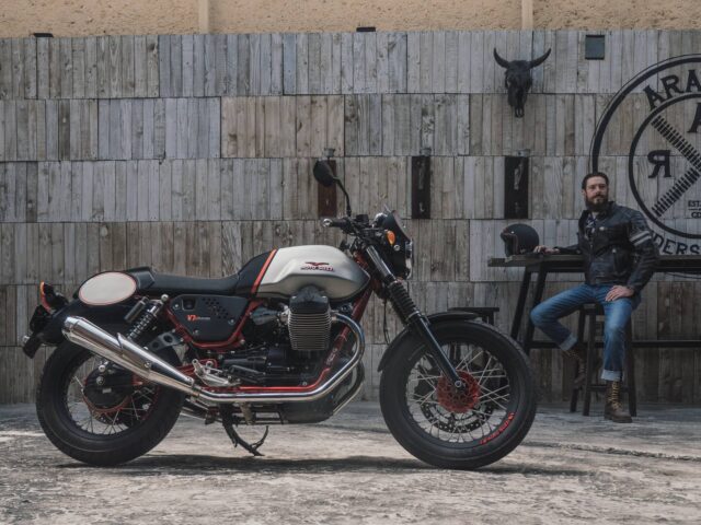 Moto Guzzi V7 Racer Motorcycle with Rider Sitting in Classic Garage Background