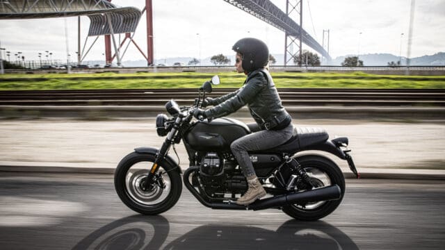 Moto Guzzi V7 Rider on Black Motorcycle with Bridge Background Wallpaper