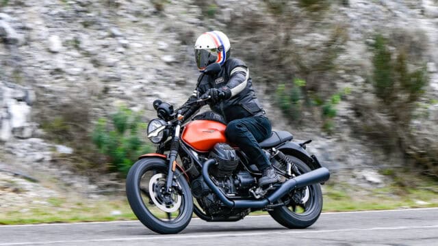 Moto Guzzi V7 Rider on Scenic Mountain Road Wallpaper