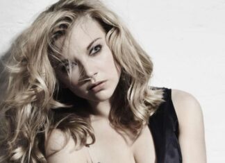 Natalie Dormer Elegant Portrait Pose, A Portrait Of Natalie Dormer Sitting Against A White Wall Wearing A Black Dress With Tousled Hair, 4K Phone Wallpaper