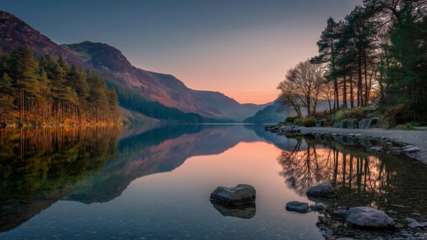 Nature Desktop Backgrounds, a serene lakeside view reflecting the surrounding mountains at dawn.