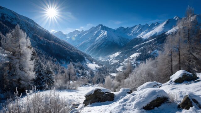 Nature full HD image for desktop wallpaper, a picturesque valley surrounded by mountains covered in snow, with a bright sun illuminating the scene.