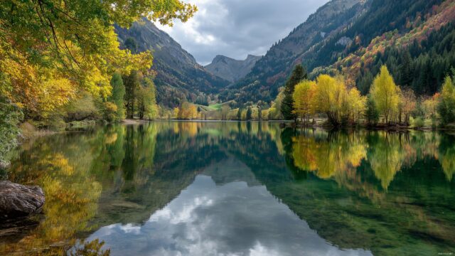 Nature wallpaper for desktop HD, a serene mountain lake reflecting the colorful autumn trees.
