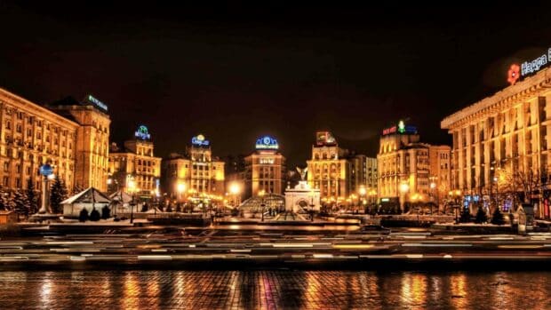 The night cityscape of Kyiv shows beautifully lit buildings and busy traffic under a dark sky featuring Ukraine Wallpapers, 2K Desktop Wallpaper