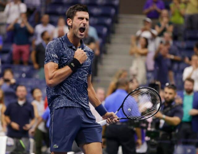 Novak Djokovic Celebrates Victory On Tennis Court Wallpaper