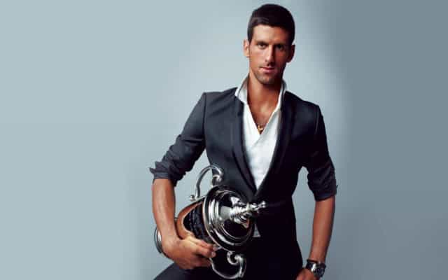 Novak Djokovic Elegant Trophy Pose Wallpaper For Download