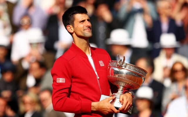 Novak Djokovic Holding Trophy Celebrating Victory Wallpaper