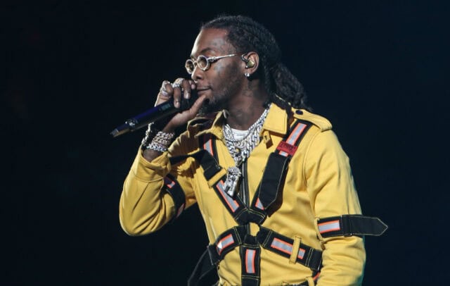 Offset Rapper Performing Live in Yellow Outfit with Chains on Stage Wallpaper