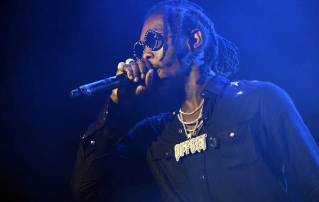 Offset Rapper Performing Live with Signature Chains and Stylish Sunglasses Wallpaper