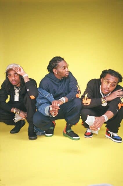 Offset Rapper and Crew Stylish Urban Pose on Yellow Background Wallpaper