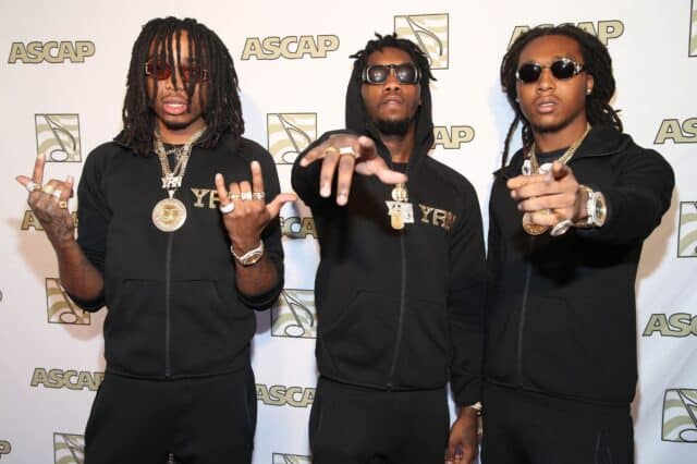 Offset rapper and YRN crew posing at ASCAP event in black outfits and gold accessories wallpaper