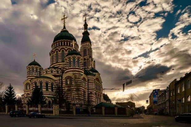 An Orthodox church stands tall under a dramatic cloudy sky in Ukraine, 2K Desktop Wallpaper