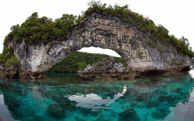 Palau Rock Arch Over Crystal Blue Waters Wallpaper