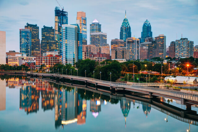 Philadelphia Skyline Wallpaper HD Desktop, Philadelphia Skyline Reflected On Calm River During Evening With Illuminated Buildings And Clear Sky