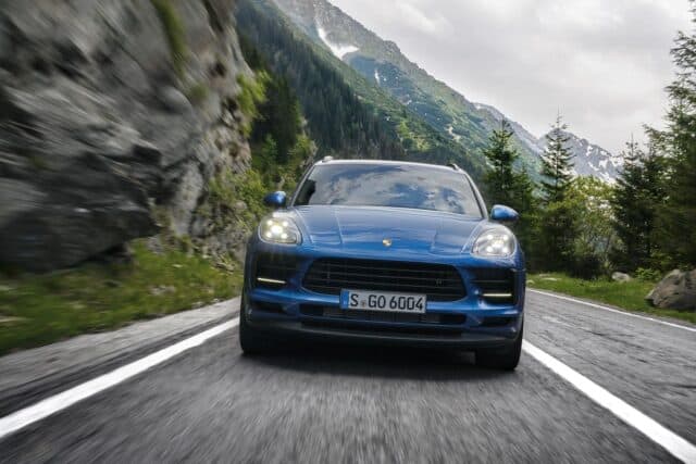 Porsche Macan Driving Through Scenic Mountain Road Stunning Blue SUV Wallpaper