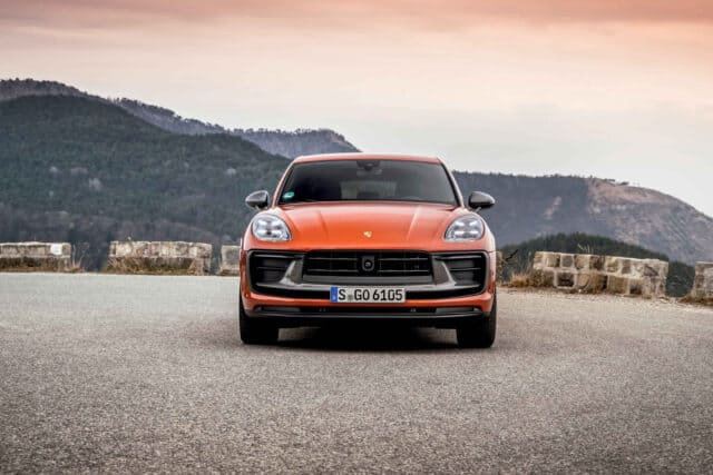 Porsche Macan Front View on Mountain Road Stunning Orange SUV Wallpaper