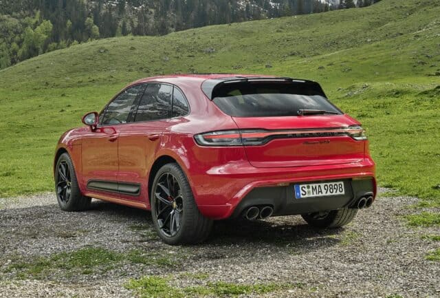 Porsche Macan GTS Red SUV Rear View in Scenic Green Landscape Wallpaper