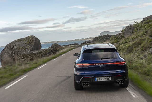 Porsche Macan driving on scenic coastal road high quality wallpapers background