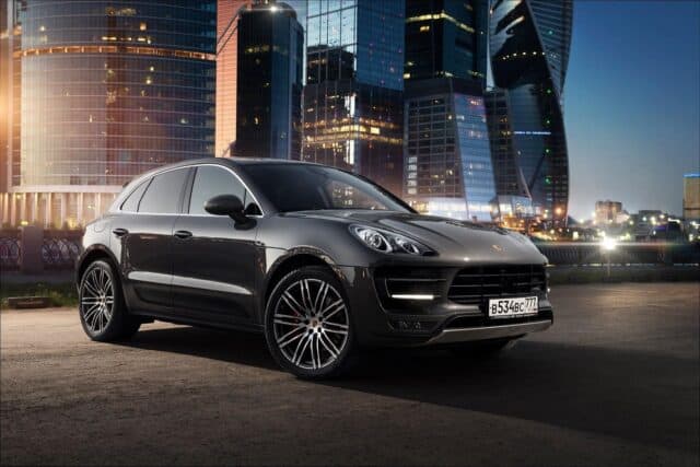 Porsche Macan parked in urban night cityscape premium SUV wallpaper